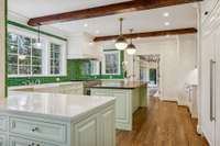 One of my favorite kitchens of all time.  Bright and open, unique… this is a happy place, and a fully functional space as well!