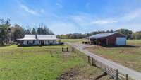 Sprawling 40-acre farm with 8 acres fenced for cattle, featuring a charming farmhouse and a spacious shop. Perfect blend of rural living and practicality, offering ample space for farming, livestock, and storage in a peaceful countryside setting.