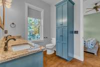 Elegant owner's bath featuring a tall linen cabinet for abundant storage. This design blends seamlessly, providing a practical solution for towels and toiletries while maintaining the room's clean, organized, and sophisticated aesthetic.
