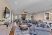 A spacious open great room with sleek concrete floors and 10-foot ceilings, offering a seamless flow. Large windows provide breathtaking views of the 40-acre farm, blending indoor comfort with expansive outdoor beauty in a bright, airy space.