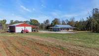 A picturesque barn-style shop on 40 acres, perfectly complementing a 3-year-old farmhouse.
