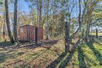 Adorable chicken coop that matches the shop and remains with the home. Also one fenced run with the coop.