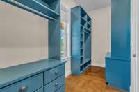 Gorgeous blue cabinetry in this oversized owner's walk-in closet. Shoe cubbies, drawers and hanging rods -- it has it all!