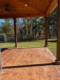 This 2500 sq ft wraparound porch is an absolute dream with elegant wood ceilings, stamped concrete, 14 outdoor ceiling fans and 28 outside lights, including floodlights on both the farmhouse and the shop. A real show piece at night!