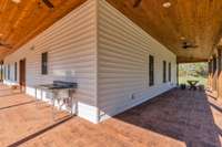 This charming wraparound covered porch features an outdoor workstation with a sink, perfect for gardening, cleaning up, etc. This porch also has 12 outdoor plugs and 4 are wired into ceiling fans for Christmas lights! No detail not thought of!