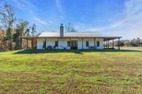 Offering panoramic views of 40 acres of lush land, the home combines rustic charm with modern comforts, providing a perfect retreat with ample outdoor space for relaxation and recreation.