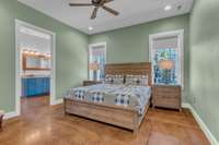 Spacious owner's retreat with ceiling fan for added comfort. The room offers ample space for relaxation, featuring soft lighting, large windows, and a serene atmosphere, making it the perfect sanctuary to unwind at the end of the day.