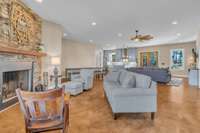 Open floorplan featuring a cozy hearth area, spacious living room, and dining area, all flowing seamlessly into the kitchen. The layout creates an inviting, connected space where family and guests can easily gather and enjoy time together.