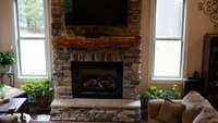 Floor to ceiling stone, gas fireplace.