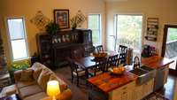 View of living area, kitchen, and dining area from stairs