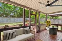 Unwind on your screened back porch.  Bug free! This photo is virtually staged