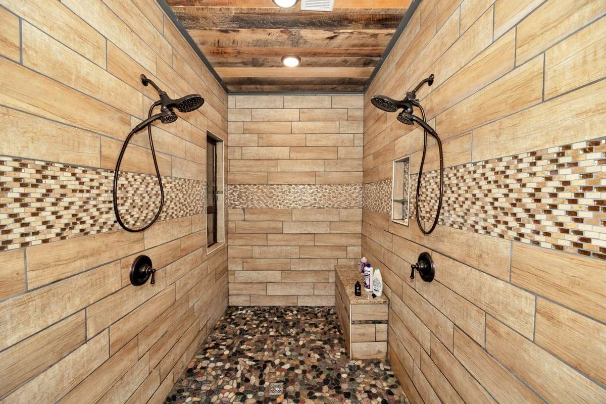 Master Bath- main level- poplar flooring, hickory walls, double vanities, soaking tub, custom window, custom tile shower with two shower heads, recessed lighting
