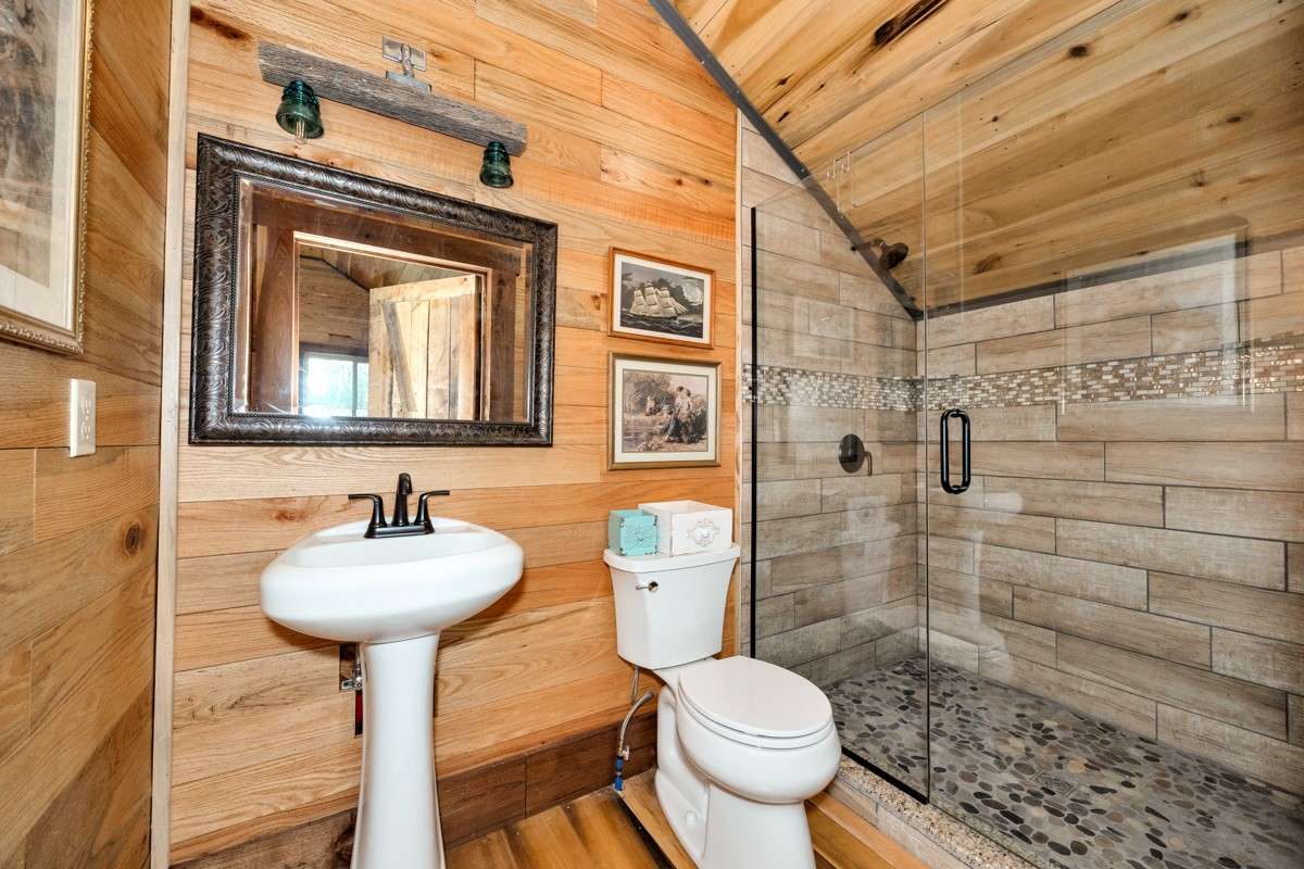 Upstairs 3/4 bath - wood flooring, hickory walls, custom tile shower