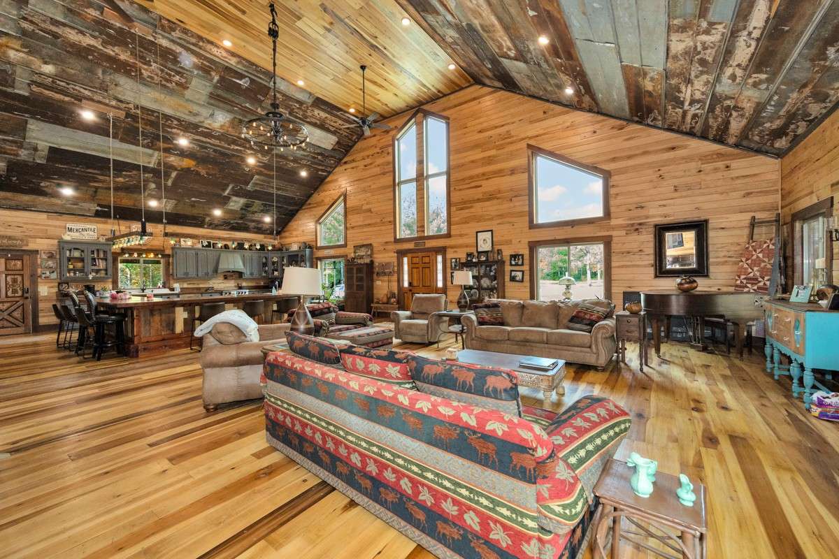 Living Room- main floor- poplar flooring, hickory walls, vaulted metal ceiling, recessed lighting, large windows