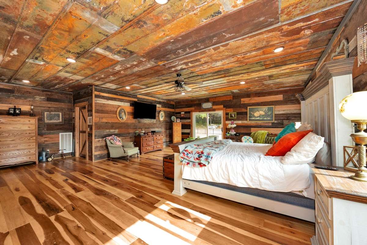 Master Bedroom - Main floor - poplar wood flooring, hickory walls, two walk-in closets, metal ceiling, ceiling fan, recessed lighting