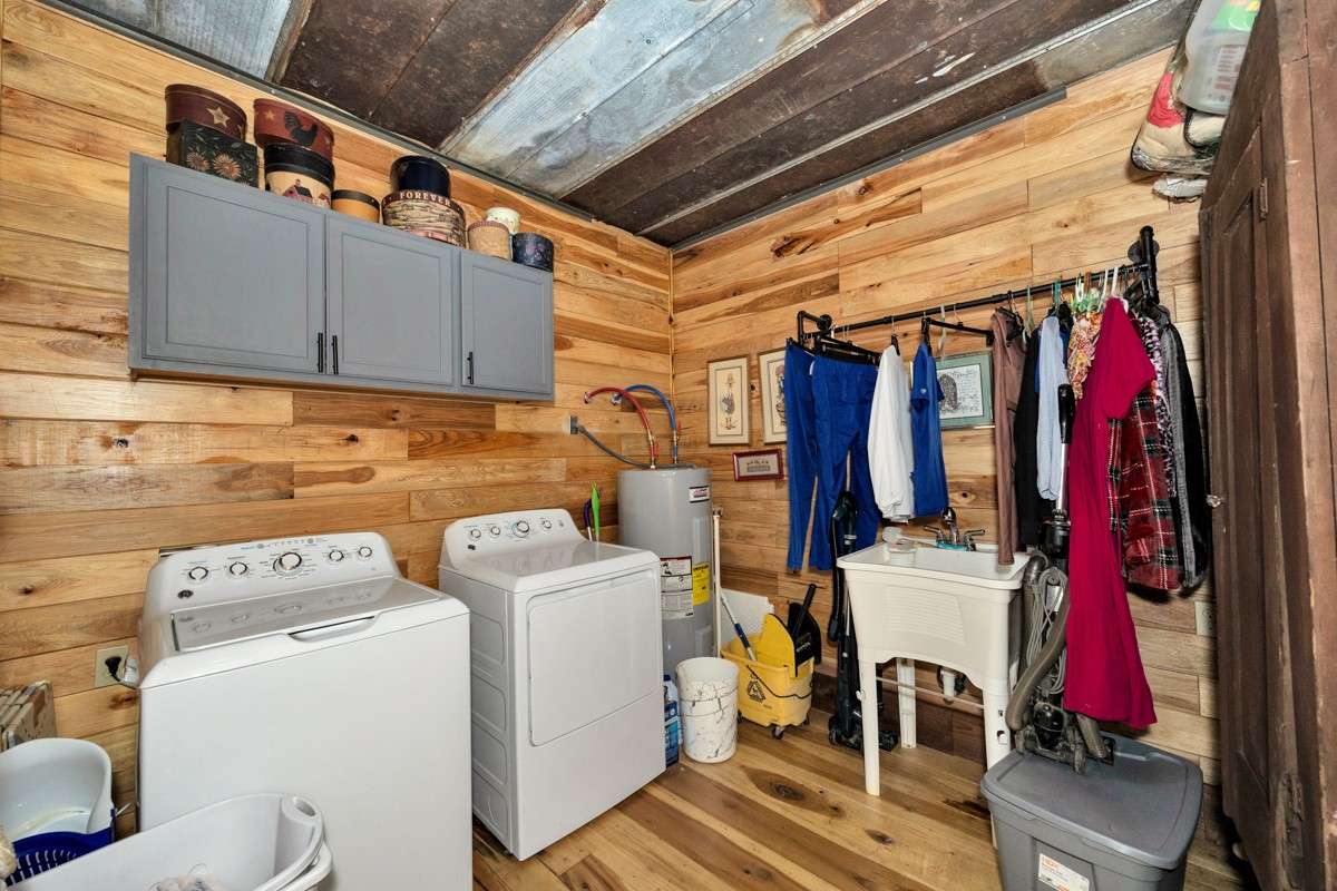 Laundry Room- Main floor- poplar flooring, metal ceiling, utility sink