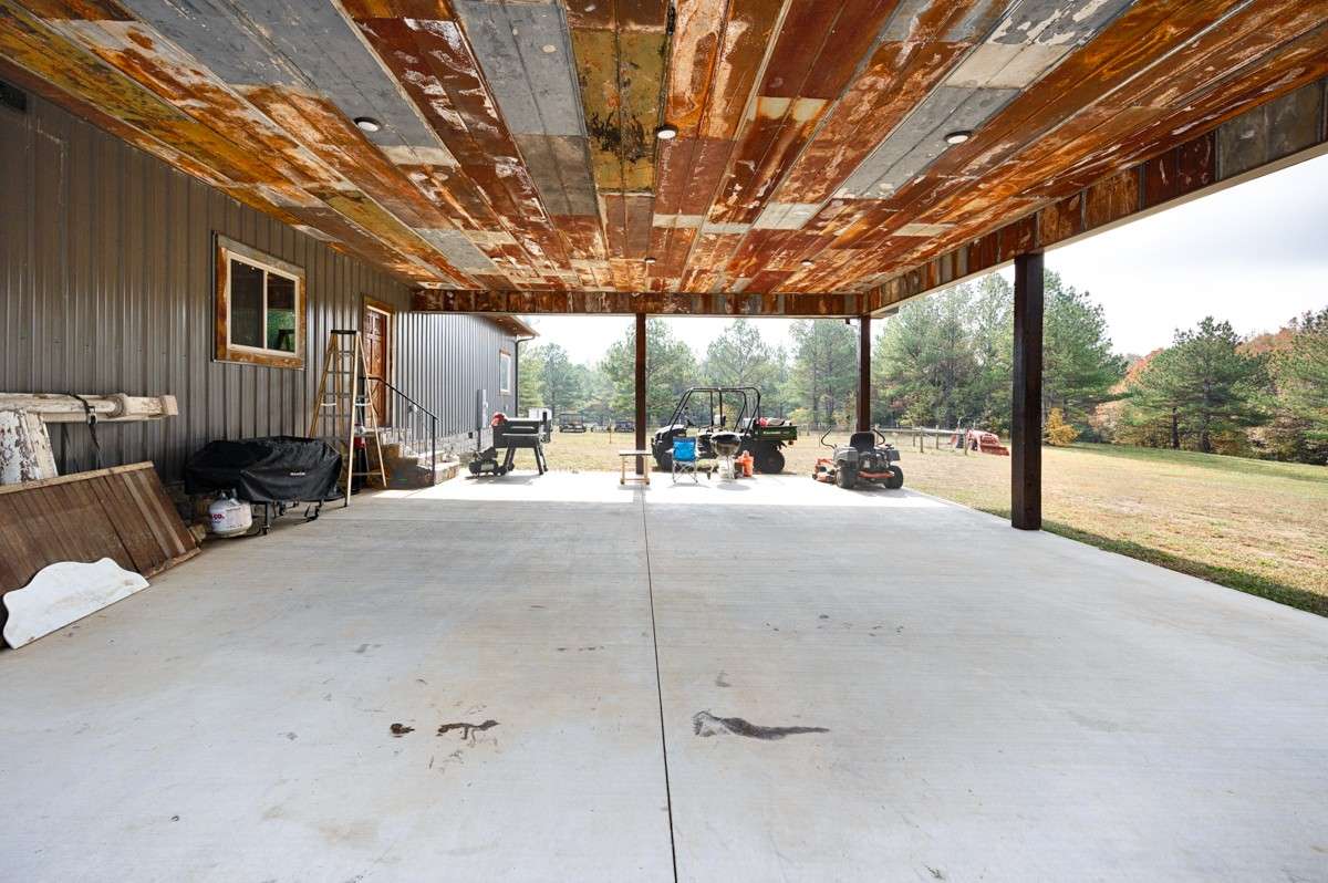 Carport - concrete pad, metal ceiling, recessed lighting