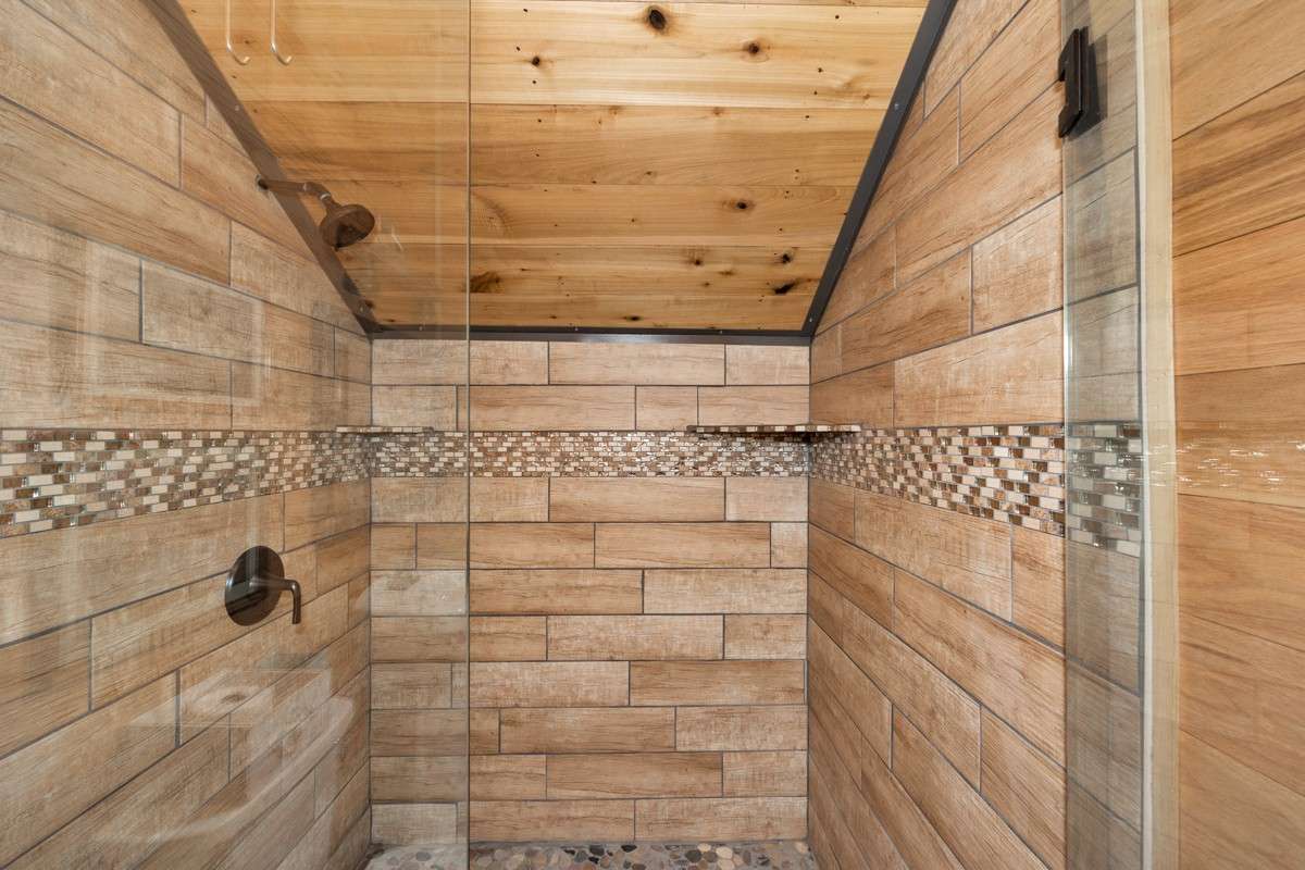 Upstairs 3/4 bath - wood flooring, hickory walls, custom tile shower