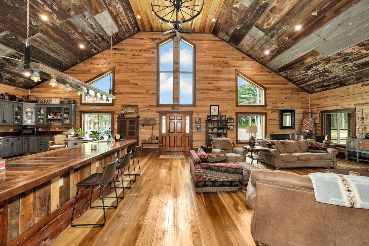 Kitchen and Living Room- main floor- poplar flooring, hickory walls, vaulted metal ceiling, recessed lighting, large windows, ceiling fan