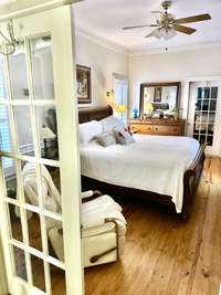 Primary beedroom - entry through glass French doors.
