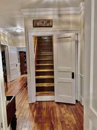 Staircase leading up to 2nd story. Offers a doorway therefore heat & air can be controlled.