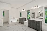 The primary spa-like bath features double vanities, a private restroom area, and a farmhouse bathtub—all strategically positioned to offer stunning views of the expansive property, inviting the beauty of the outdoors inside.