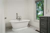 Farmhouse bathtub—Strategically positioned to offer stunning views of the expansive property, inviting the beauty of the outdoors inside.