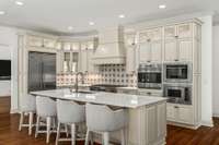 Dine at the bar while the chef crafts a gourmet meal in this luxurious, chef-appointed kitchen—designed for both functionality and elegance, perfect for culinary enthusiasts.