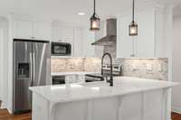 Renovated kitchen featuring stylish pendant lighting and stainless steel appliances—offering both function and charm. A true gem, perfectly suited for a guest retreat or secondary home.
