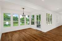 Breakfast nook with door to the patio, ideal for entertaining or grilling. Expansive rear windows flood the space with light, offering captivating views and sunsets that make time stand still.