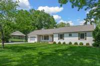 Renovated 2,055 sq ft secondary farmhouse with 3 beds, 2 baths, 1-car garage, and outdoor parking pavilion.