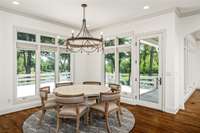 Create lasting memories in a space flooded with natural light from expansive windows, offering tranquil views of the property and lake. Whether enjoying coffee or a meal, the sensory experience of serenity surrounds you.