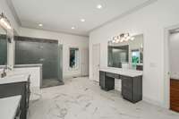The luxurious walk-in spa shower and additional makeup vanity add to the thoughtful design of the primary bath, offering both functionality and a tranquil, refined space to unwind.