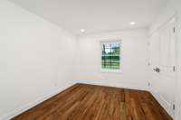 Another guest bedroom offering charming views of the equestrian paddocks.