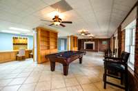 Lower level is services by level and has covered porch, gas fireplace, tile floor. This level also has full kitchen, bar, giant pantry, bedroom, and full bath.
