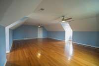Upper level with full bath  has four large connected rooms that can be used in a variety of ways. Two smaller rooms are carpeted and two larger have wood floors.