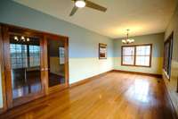 Sunny family room is surrounded by windows with property views.