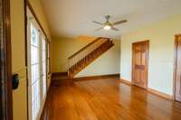 Office on main level with half bath and french doors to covered back deck. Stairs go to upper level.