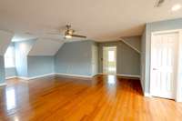Upper level with full bath  has four large connected rooms that can be used in a variety of ways. Two smaller rooms are carpeted and two larger have wood floors.