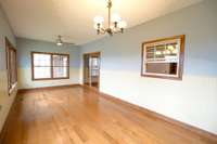 Sunny family room has pass through to kitchen and door to dining room