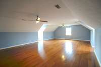 Upper level with full bath  has four large connected rooms that can be used in a variety of ways. Two smaller rooms are carpeted and two larger have wood floors.