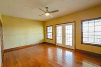 Office on main level with half bath and french doors to covered back deck.
