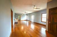 Large living room on the main floor. Door on the right is elevator access.