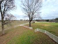 View of side year and gate to fenced back yard from back porch