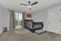 Second floor bedroom with large storage area behind door.