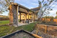 When the sun sets, use the remote control to lower automatic shades so you can see the TV posted above the gas outdoor fireplace.