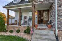 Take a moment to relax on this front porch, enjoy the fresh air and watch the world go by.