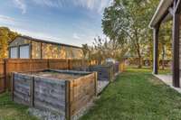 Another view of the four raised garden beds with the chicken coop just to the rear.
