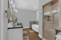 Main bathroom with oversize designer tub and shower with specialty tile