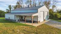 Building with 14' garage doors.  The side lean to is ready to build out an apt.